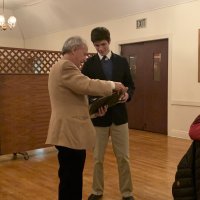 1/15/20 - Student Speaker Contest at the I.A.S.C - Topic: Homelessness in California: What is the Solution? - Lion Chairman Paul Corvi presenting winner’s check and certificate to Michael Gray. Lion Bob Fenech on the right.