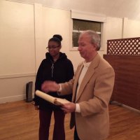 1/15/20 - Student Speaker Contest at the I.A.S.C - Topic: Homelessness in California: What is the Solution? - Student speaker Xiomara Larkin stands by as Lion Chairman Paul Corvi reads her first runner up certificate to the audiance.