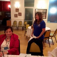 11-17-21 - San Francisco Unified Lions Club Visitation, IASC, San Francisco - Lion President Carol Fung (standing) talking about the S. F. Unified Club’s activities. Zenaida Lawhon on left.