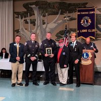 4-30-22 - 2022 Police, Firefighters & Sheriffs Award Night, Scottish Rite Masonic Center, San Francisco - L to R: (at table) guest, guest, District Governor Jun Valera, Captain of Ingleside Station, Officer Matthew Seavey, President Robert Lawhon, SF Council President August Valera, announcer.