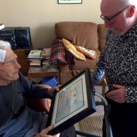 8/19/21 - Al Gentile’s Home, San Mateo - Lion Al Gentile holds his Certificate of Service for 64 years of service while Lion Bob Lawhon gives him some additional background.