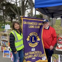 10-17-21 - Outer Sunset Farmers Market & Mercantile, 37th Avenue between Ortega & Pacheco, San Francisco - Lions Carol Fung and Bob Lawhon pause and pose with the S. F. Unified Lions banner.