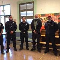 12-10-21 - Mission Education Center Christmas with Santa @ MEC, San Francisco - Firefighters with Los Bomberos, along with Steve Martin (center right) take time to pose before meeting with students.