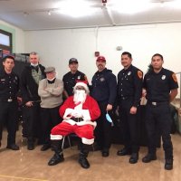 12-10-21 - Mission Education Center Christmas with Santa @ MEC, San Francisco - Steve Martin and Bob Lawhon (second and third from left) pose with members of Los Bomberos Firefighters, including Santa.