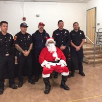 12-10-21 - Mission Education Center Christmas with Santa @ MEC, San Francisco - Members of Los Bomberos Firefighters, including Santa.