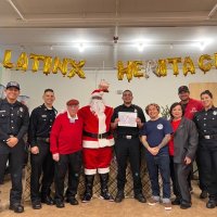 12-9-22 - Mission Education Center Christmas with Santa, San Francisco - Members of Los Bomberos with Bob (3rd from left) & Zenaida (3rd from right) Lawhon before the festivities began.