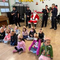 12-9-22 - Mission Education Center Christmas with Santa, San Francisco - Students from one of the classes pose with Santa.