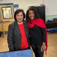 12-9-22 - Mission Education Center Christmas with Santa, San Francisco - Zenaida Lawhon poses with one of the teachers.