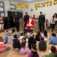 12-9-22 - Mission Education Center Christmas with Santa, San Francisco - Students play close attention as Santa talks to them.