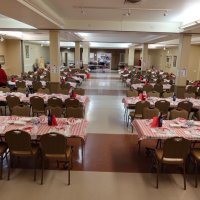 2-25-23 - 36th Annual Crab Feed - St. Philip the Apostle Church, San Francisco - View of the hall, from the back, after setup was completed - just waiting for guests to arrive. Sharon Eberhardt on the left; at front table: Bill Graziano, Bob Lawhon, and the church’s Pastor; Steve Martin in the kitchen.