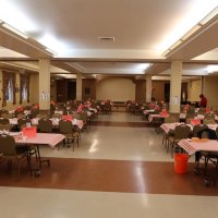 2-25-23 - 36th Annual Crab Feed - St. Philip the Apostle Church, San Francisco - View of the hall, from the front, after setup was completed. At table on right: Bob Lawhon, facing camera, and the church’s Pastor. Sharon Eberhardt is on the right toward the back.
