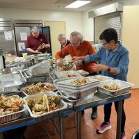2-25-23 - 36th Annual Crab Feed - St. Philip the Apostle Church, San Francisco - Getting the crab into serving trays are, L to R, Bob Fenech, Rose Ann Harris, Paul Corvi, and Leona Wong.
