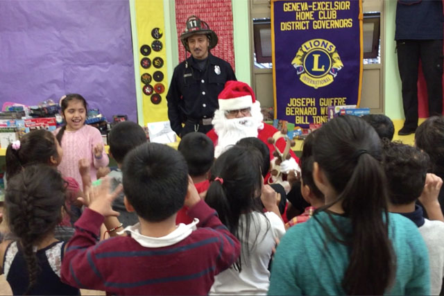 Students Singing with Santa and his Staff